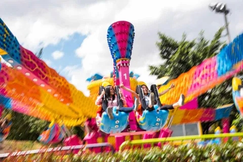 Two girls on a moving amusement ride.