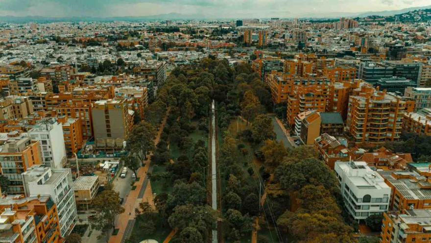 Park seen from above, vertically, surrounded on the left and right by dense trees.