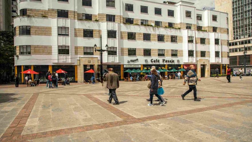 People walking in a plaza, enjoying the atmosphere and socializing.