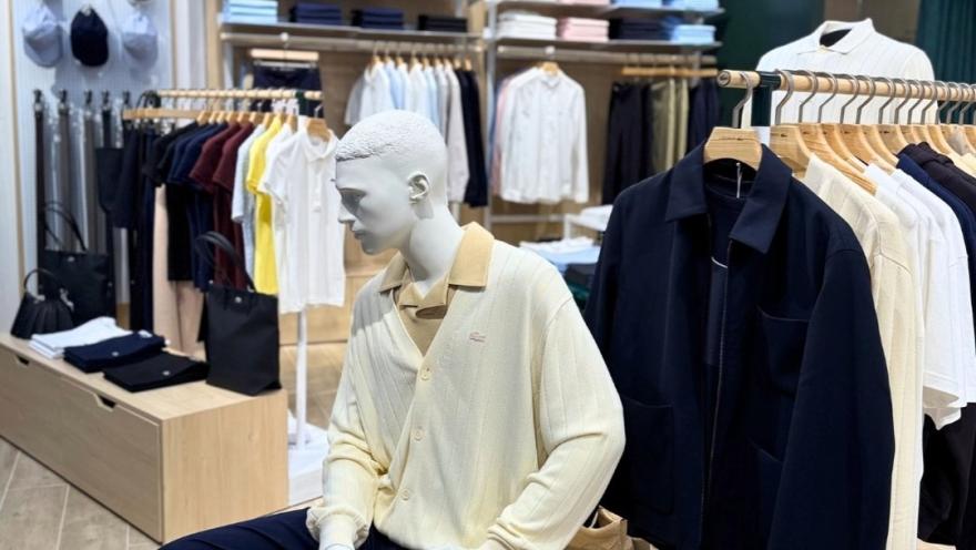 Interior de una tienda de ropa con prendas exhibidas en estanterías y un maniquí vestido con ropa casual elegante.