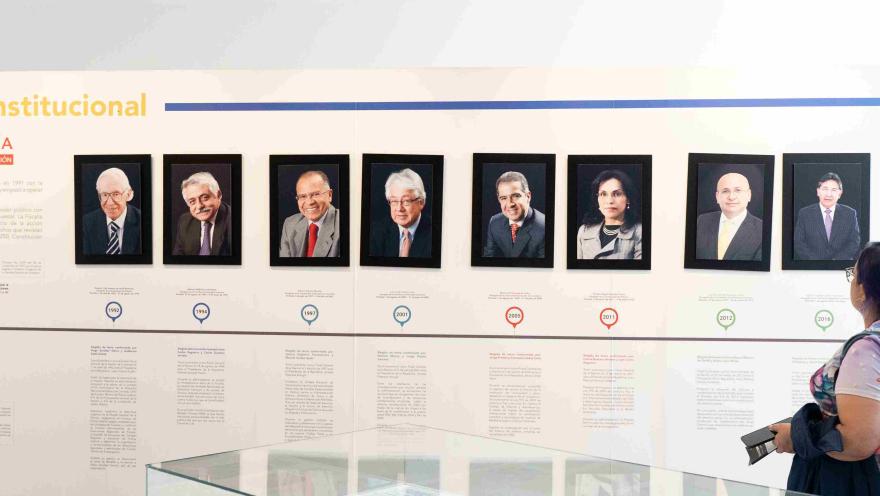 A museum exhibit presenting an institutional timeline with portraits of former officials and historical documents.