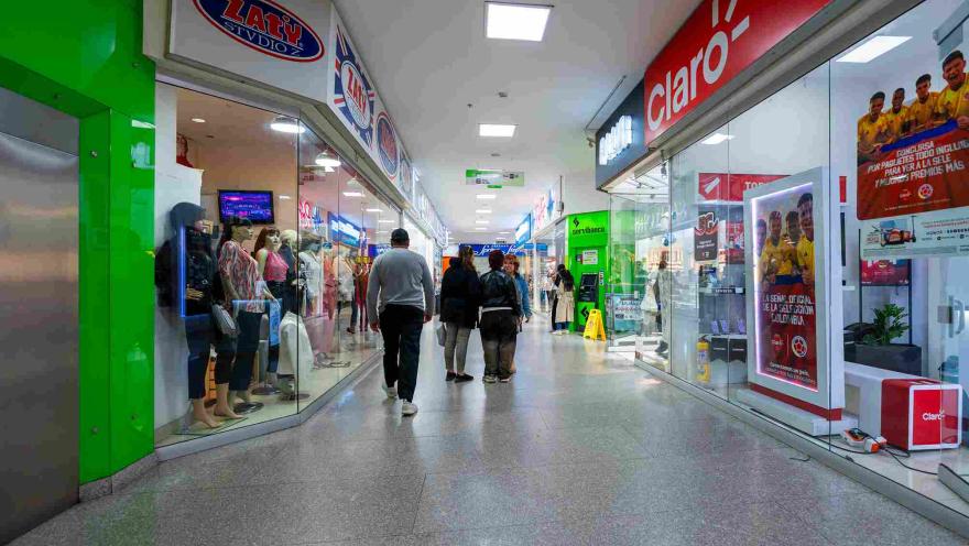 Pasillo comercial del Centro Comercial Galerías, con una amplia variedad de tiendas y visitantes recorriendo sus espacios.