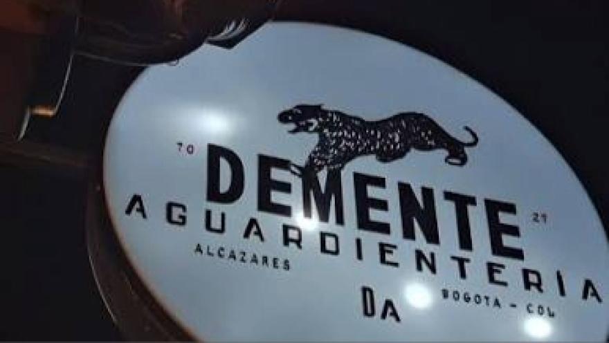 Sign for Demente Aguardientería Alcázares, featuring its characteristic tiger as a symbol and a taste of Colombian flavor.