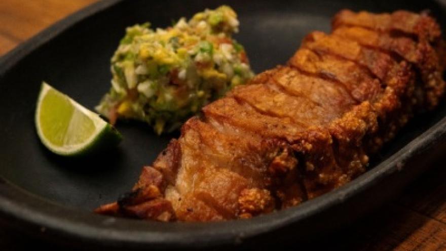 Golden, crispy ribs, served with a fresh avocado side dish and a touch of lime.