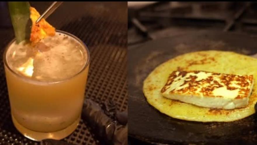 A citrusy, refreshing drink alongside a golden arepa with cheese, a combination celebrating Colombian flavors.